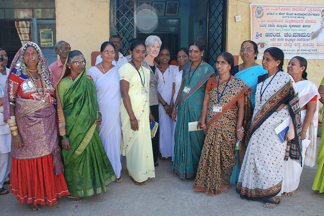 A group of Indian midwives stand in front of a New Delhi health center.